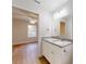 Bright bathroom features granite countertops, white cabinets, chrome hardware, and views into the bedroom at 24264 Sw South Hills Ct, Dunnellon, FL 34431