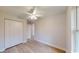Comfortable bedroom with closet space, wood-look flooring, and a neutral color palette at 24264 Sw South Hills Ct, Dunnellon, FL 34431