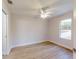 This bedroom features wood-look flooring, a ceiling fan, and a window with a view at 24264 Sw South Hills Ct, Dunnellon, FL 34431