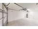 A spacious two car garage with concrete flooring and a hot water tank at 24264 Sw South Hills Ct, Dunnellon, FL 34431