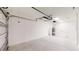 Bright garage with white walls, concrete floor, automatic door opener, and water heater at 24264 Sw South Hills Ct, Dunnellon, FL 34431