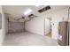 Spacious two car garage with automatic door opener, water heater, and interior access door at 24264 Sw South Hills Ct, Dunnellon, FL 34431