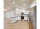 Bright kitchen with white cabinets, granite countertops, stainless appliances, and an open floor plan at 24264 Sw South Hills Ct, Dunnellon, FL 34431
