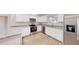 This kitchen features stainless steel appliances, granite countertops, and white cabinets with chrome hardware at 24264 Sw South Hills Ct, Dunnellon, FL 34431