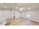 Bright living room featuring wood-look flooring, a ceiling fan and an open concept design at 24264 Sw South Hills Ct, Dunnellon, FL 34431