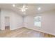 Open-concept living room featuring modern lighting, hard surface flooring, and a large front window at 24264 Sw South Hills Ct, Dunnellon, FL 34431