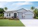 Charming single-story home featuring a three-car garage and professionally landscaped front yard at 3079 Canopy Oak Blvd, Wildwood, FL 34785