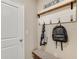 This mud room has a hall tree, storage bench, coat hooks, and tile flooring at 3079 Canopy Oak Blvd, Wildwood, FL 34785