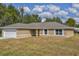 Charming ranch-style home featuring a two-car garage and a well-maintained lawn at 38 Juniper Loop Way, Ocala, FL 34472