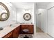 Well-lit bathroom with double vanity, tile flooring, and framed mirrors at 415 Cierra Oaks Cir, Lady Lake, FL 32159