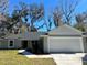 Charming single-story home with gray exterior, green lawn, and a two-car garage at 4721 Nw 67Th St, Ocala, FL 34482