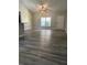 Bright living room features stylish flooring, neutral walls, fan, and a large window at 4721 Nw 67Th St, Ocala, FL 34482