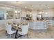 A modern kitchen with stainless steel appliances, granite countertops, and a dining area with seating at 4766 Nw 39Th Street Rd, Ocala, FL 34482