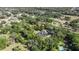 Overhead view showcases the house amidst green trees in a neighborhood at 4940 E Fort King St, Ocala, FL 34470