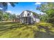 Expansive backyard featuring a well-maintained lawn, screened porch and screened pool at 4940 E Fort King St, Ocala, FL 34470