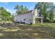 A large backyard with a white house and enclosed patio at 4940 E Fort King St, Ocala, FL 34470