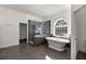 Spacious bathroom with a soaking tub, glass-enclosed shower, and tiled flooring, providing a spa-like experience at 4940 E Fort King St, Ocala, FL 34470