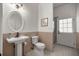 Cozy bathroom with pedestal sink, stylish fixtures, and a walk-in shower at 4940 E Fort King St, Ocala, FL 34470