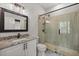 Modern bathroom featuring sleek black hardware, granite countertops, and a glass-enclosed shower at 4940 E Fort King St, Ocala, FL 34470