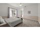 Bright bedroom features neutral carpet and walls and features a large window with light-filtering drapes at 4940 E Fort King St, Ocala, FL 34470