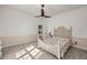 Sunlit bedroom with ceiling fan and a cozy bed, creating a warm and inviting atmosphere at 4940 E Fort King St, Ocala, FL 34470