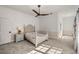 Bright bedroom with a charming bed, ceiling fan, and sunlight streaming through the windows at 4940 E Fort King St, Ocala, FL 34470