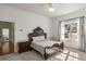 Cozy bedroom with large windows, neutral carpet and bed frame and features chair-rail detailing at 4940 E Fort King St, Ocala, FL 34470