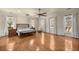 Large bedroom featuring wood floors and big bright windows with white drapery at 4940 E Fort King St, Ocala, FL 34470