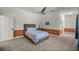 Well lit bedroom featuring 2 windows, paint with chair railing and a plush bed at 4940 E Fort King St, Ocala, FL 34470