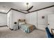 Comfortable bedroom with a ceiling fan, neutral tones, and carpeted floors at 4940 E Fort King St, Ocala, FL 34470