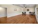 A spacious bonus room with beautiful hardwood floors, wainscoting, a ceiling fan, and plenty of natural light at 4940 E Fort King St, Ocala, FL 34470