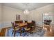 Elegant dining room featuring hardwood floors, chandelier, and classic chair rail molding at 4940 E Fort King St, Ocala, FL 34470