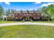 Stately two-story brick home featuring a circular driveway, manicured lawn and mature trees, creating an inviting curb appeal at 4940 E Fort King St, Ocala, FL 34470