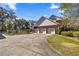 Exterior view of the home featuring a three-car garage and ample parking space at 4940 E Fort King St, Ocala, FL 34470