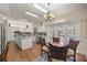 Bright kitchen features white cabinets, granite counters, island cooktop, and a breakfast nook at 4940 E Fort King St, Ocala, FL 34470