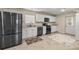 Modern kitchen featuring stainless steel appliances, white cabinetry, and tiled floors at 4940 E Fort King St, Ocala, FL 34470
