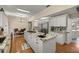 Bright eat-in kitchen features granite counters, an island cooktop, and stainless steel appliances at 4940 E Fort King St, Ocala, FL 34470