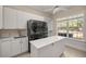 Bright laundry room with stacked washer/dryer, sink, island and a large window at 4940 E Fort King St, Ocala, FL 34470