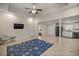 Open-concept living room featuring modern tile floors, neutral walls, and a ceiling fan at 4940 E Fort King St, Ocala, FL 34470