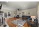 Spacious living room with hardwood floors, a ceiling fan, and comfortable blue seating at 4940 E Fort King St, Ocala, FL 34470