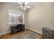 Home office featuring hardwood floors, a ceiling fan, and a large window at 4940 E Fort King St, Ocala, FL 34470