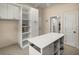 Well-organized pantry with island and custom shelving, ideal for storage and organization at 4940 E Fort King St, Ocala, FL 34470