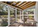 Relaxing screened porch with wood flooring and a view of the backyard at 4940 E Fort King St, Ocala, FL 34470