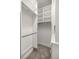 Neat walk-in closet featuring white shelving, drawers, and carpeted flooring at 4940 E Fort King St, Ocala, FL 34470