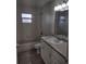 Clean bathroom features a white vanity, a large mirror, and tub/shower combination at 5355 3 Pl, Ocala, FL 34482