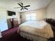 Bedroom featuring a ceiling fan, tv and large window at 5806 Sw 109Th Street Rd, Ocala, FL 34476