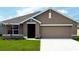 Charming single-story home with well-manicured lawn and attached two-car garage at 7144 Se 113Th Ln, Belleview, FL 34420