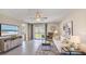 Bright living room with tile flooring, modern furnishings, and sliding glass doors to the backyard at 8470 Las Palmas Way, Wildwood, FL 34785