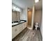 Well-lit bathroom featuring double vanity sinks, with granite countertops, and a tile shower for a luxurious feel at 1 Fisher Lane Way, Ocklawaha, FL 32179