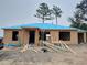 Unfinished new home under construction showing bare framing and a ladder near the entrance at 1 Fisher Lane Way, Ocklawaha, FL 32179